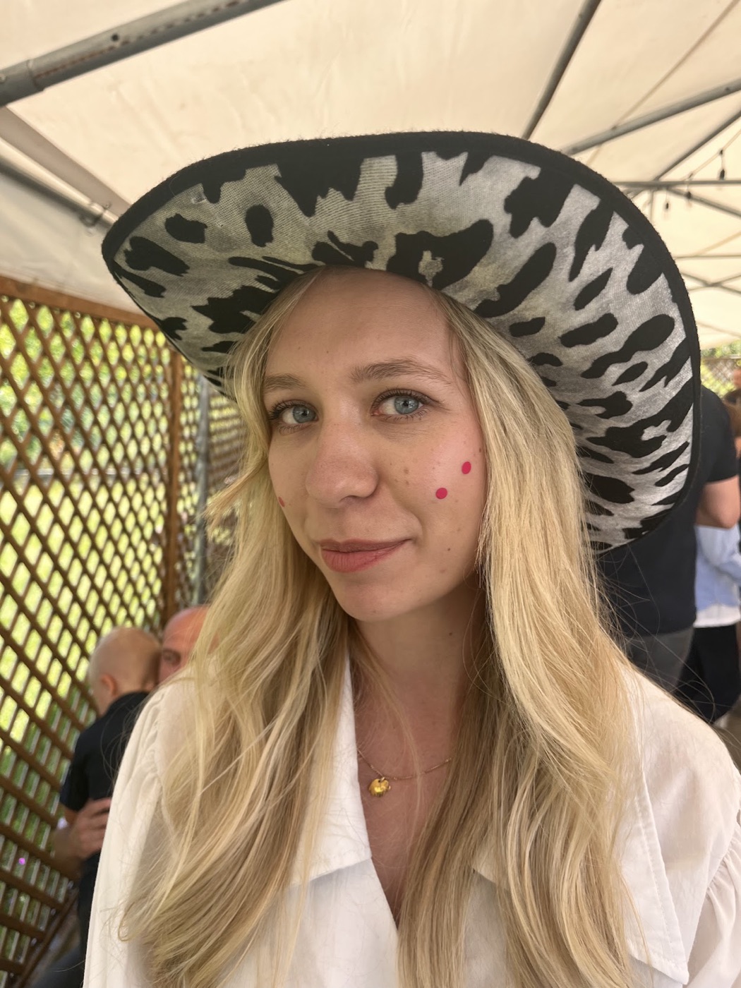 Alice outdoors in a wide-brimmed hat